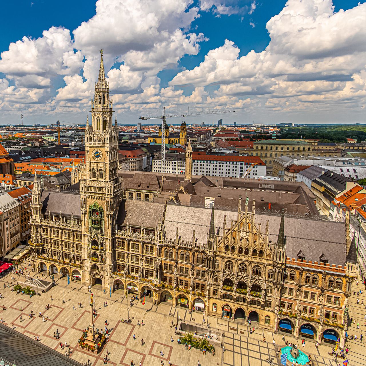 Blick vom Turm "Alter Peter" auf den Marienplatz mit Neuem Rathaus, die Farben sehr gesättigt, Marienplatz leer, insgesamt sehr kitchig.